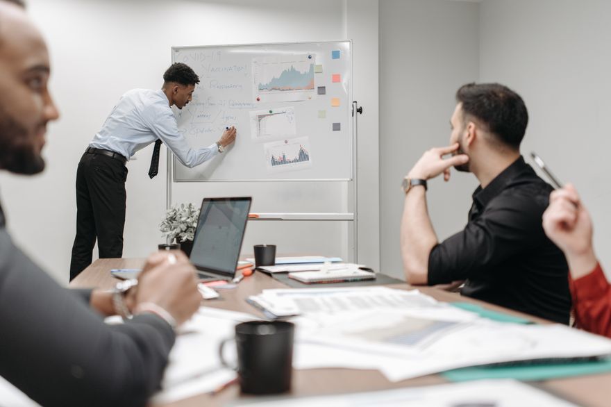 Colleagues reviewing sales and marketing plans in a meeting room